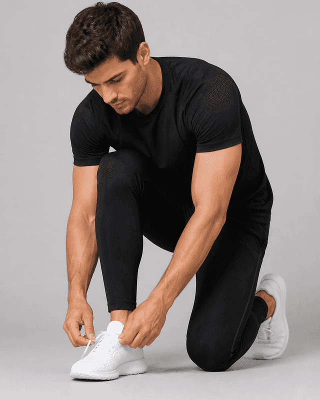 Athlete tying running shoes — Men category